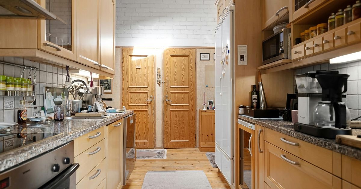 Cherry wood kitchen cabinets with deep red tones and smooth finish.