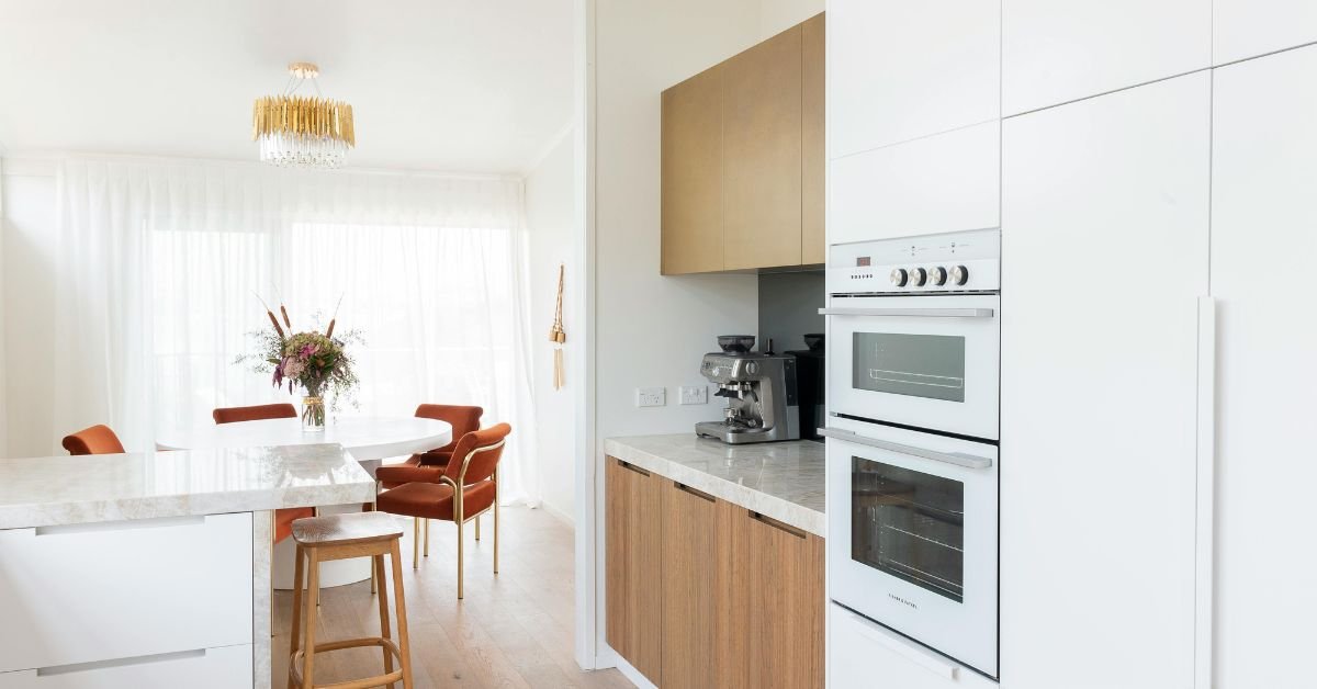 Trendy kitchen with stylish walnut kitchen cabinets.