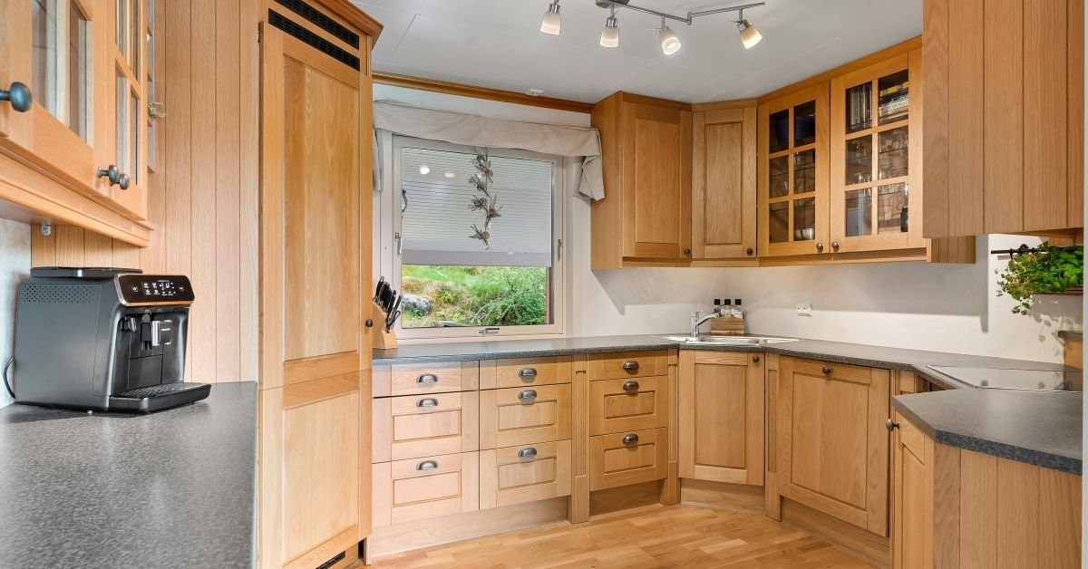 Professional installation of walnut cabinets in a kitchen.